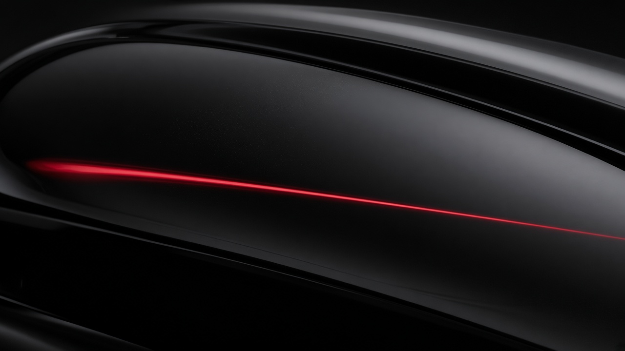 Tight crop of black paint with a single crimson reflection line.
